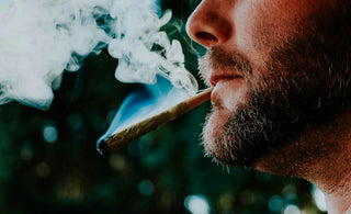 bearded man smoking a joint