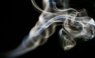 fragile smoke against a black background