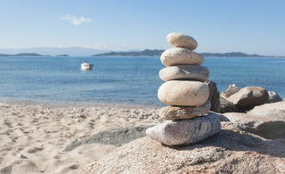 a smooth rock cairn on the beach